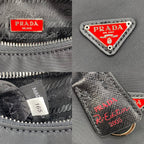 PRADA HOBO 22 BAG IN BLACK RE-NYLON WITH RED LOGO