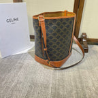 CELINE BUCKET 33 IN BLACK TRIOMPHE CANVAS AND BRONZE BROWN CALFSKIN TRIM