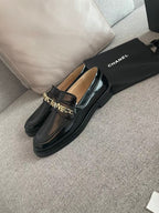 CHANEL MOASINS IN BLACK CALFSKIN GOLD METAL LOGO
