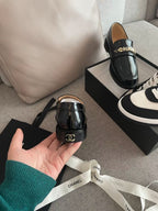 CHANEL MOASINS IN BLACK CALFSKIN GOLD METAL LOGO