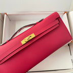 HERMES KELLY CUT 31 IN CHERRY RED CALFSKIN WITH GOLD HARDWARE