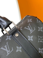 LOUIS VUITTON KEEPALL BANDOULIÈRE 25 IN BLACK MONOGRAM HERITAGE CANVAS