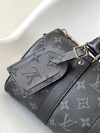 LOUIS VUITTON KEEPALL BANDOULIÈRE 25 IN BLACK MONOGRAM HERITAGE CANVAS