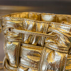 BOTTEGA VENETA SMALL CASSETTE BUCKET 18 IN GOLD METALLIC SOFT LAMBSKIN