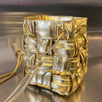 BOTTEGA VENETA SMALL CASSETTE BUCKET 18 IN GOLD METALLIC SOFT LAMBSKIN