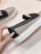 HERMES 25S SLIP-ON IN LIGHT GREY CANVAS AND BLACK LAMBSKIN