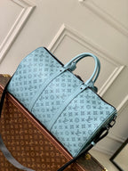 LOUIS VUITTON KEEPALL BANDOULIÈRE 50 IN SKY BLUE MONOGRAM SHADOW EMBOSSED CALFSKIN