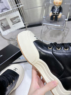 CHANEL MARTIN BOOTS IN BLACK CALFSKIN AND LAMB FUR LINING