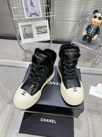 CHANEL MARTIN BOOTS IN BLACK CALFSKIN AND LAMB FUR LINING