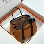 HERMES GARDEN PARTY 30CM IN ORANGE MINIMUM TOILETS COTTON CANVAS AND BLACK CALFSKIN