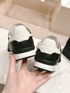 CHANEL SNEAKERS IN GLOSSY BLACK LAMBSKIN
