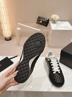 CHANEL SNEAKERS IN GLOSSY BLACK LAMBSKIN