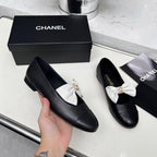 CHANEL 25S MARY JANES IN BLACK CALFSKIN WITH WHITE BOW GOLD HARDWARE
