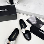 CHANEL 25S MARY JANES IN BLACK CALFSKIN WITH WHITE BOW GOLD HARDWARE