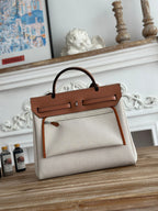 HERMES HERBAG ZIP 31 LAQUERED BAG IN OFF-WHITE MIX BROWN H PLUME CANVAS AND BROWN COWHIDE