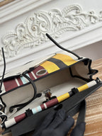 HERMES HERBAG ZIP 31 LAQUERED BAG IN BROWN MIX YELLOW H PLUME CANVAS