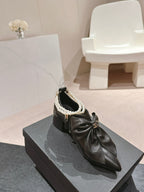 CHANEL SHORT BOOTS IN BLACK SHEEPSKIN WITH BOW