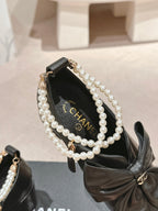 CHANEL SHORT BOOTS IN BLACK SHEEPSKIN WITH BOW