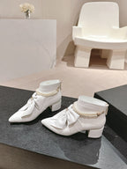 CHANEL SHORT BOOTS IN WHITE SHEEPSKIN WITH BOW