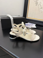 CHANEL FLAT SANDALS IN WHITE CALFSKIN WITH BOW