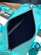 LOUIS VUITTON KEEPALL BANDOULIÈRE 25 IN TURQUOISE BLUE MONOGRAM EMBOSSED CALFSKIN