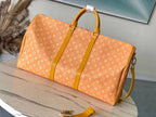LOUIS VUITTON KEEPALL BANDOULIÈRE 55 IN ORANGE MONOGRAM HERITAGE CANVAS