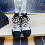 CHANEL COMBAT BOOTS IN WHITE WRINKLED CALFSKIN AND BLACK GROSGRAIN WITH FAUX PEARL