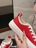CHANEL LACE-UP SNEAKERS IN CHERRY RED CANVAS