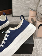 CHANEL LACE-UP SNEAKERS IN NAVY BLUE CANVAS