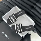 CHANEL Woven Embroidered Letter Slippers Black White