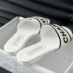 CHANEL Woven Embroidered Letter Slippers White Black