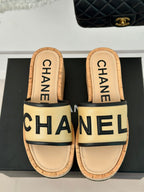 CHANEL THICK SOLE LETTER SLIPPERS IN DARK CREAM SHEEPSKIN