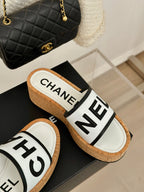 CHANEL THICK SOLE LETTER SLIPPERS IN WHITE SHEEPSKIN