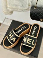 CHANEL THICK SOLE LETTER SLIPPERS IN BLACK SHEEPSKIN