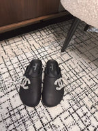 CHANEL FLAT MULES IN BLACK CALFSKIN