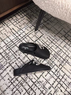 CHANEL FLAT MULES IN BLACK CALFSKIN
