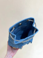 CHANEL DRAWSTRING BUCKET BACKPACK 24 IN MALIBU BLUE DENIM GOLD HARDWARE