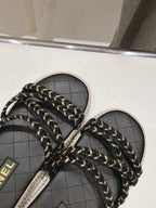 CHANEL WOVEN STRAP SLIPPERS IN BLACK LAMBSKIN