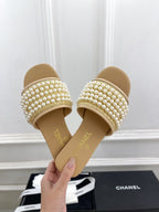 CHANEL FLAT SLIDE IN FLAX YELLOW CALFSKIN WITH PEARLS